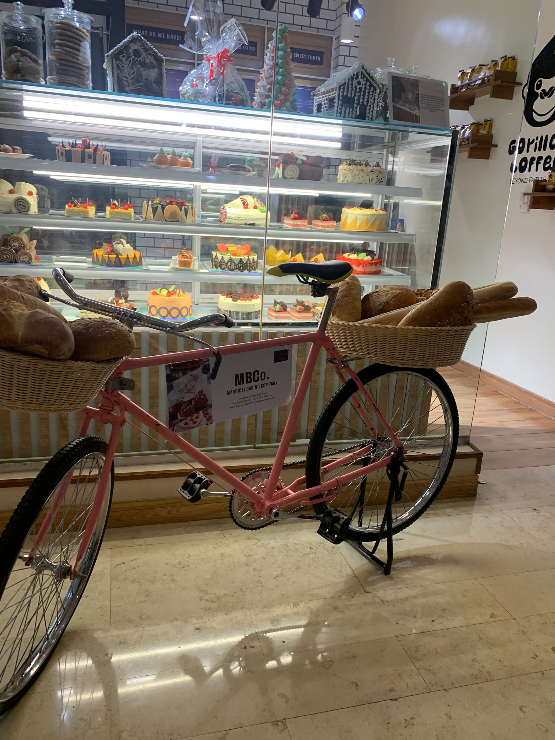 Interior of a modern bakery with colorful cakes and decorative bicycle