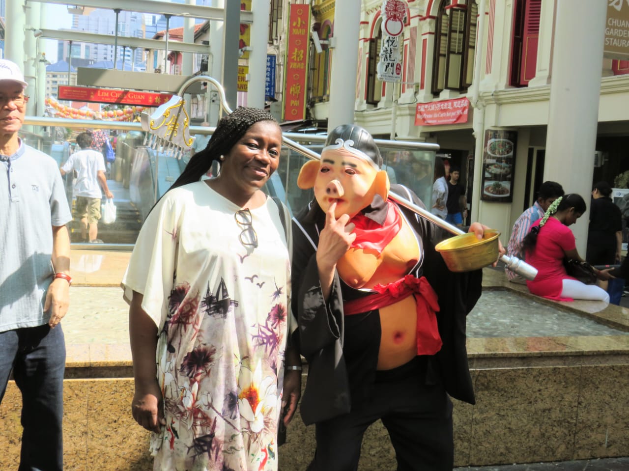 Anike with person in traditional Chinese costume in Singapore's Chinatown