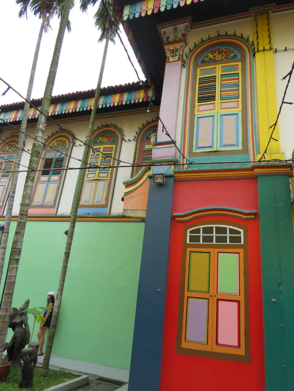Detailed view of ornate multi-colored shophouse architecture with decorative elements