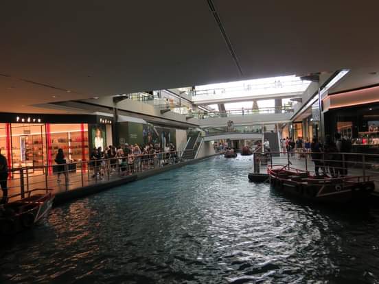 Interior canal at The Shoppes at Marina Bay Sands with traditional sampan boat