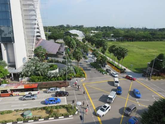 Aerial view of Singapore showing organized streets, green spaces, and urban development