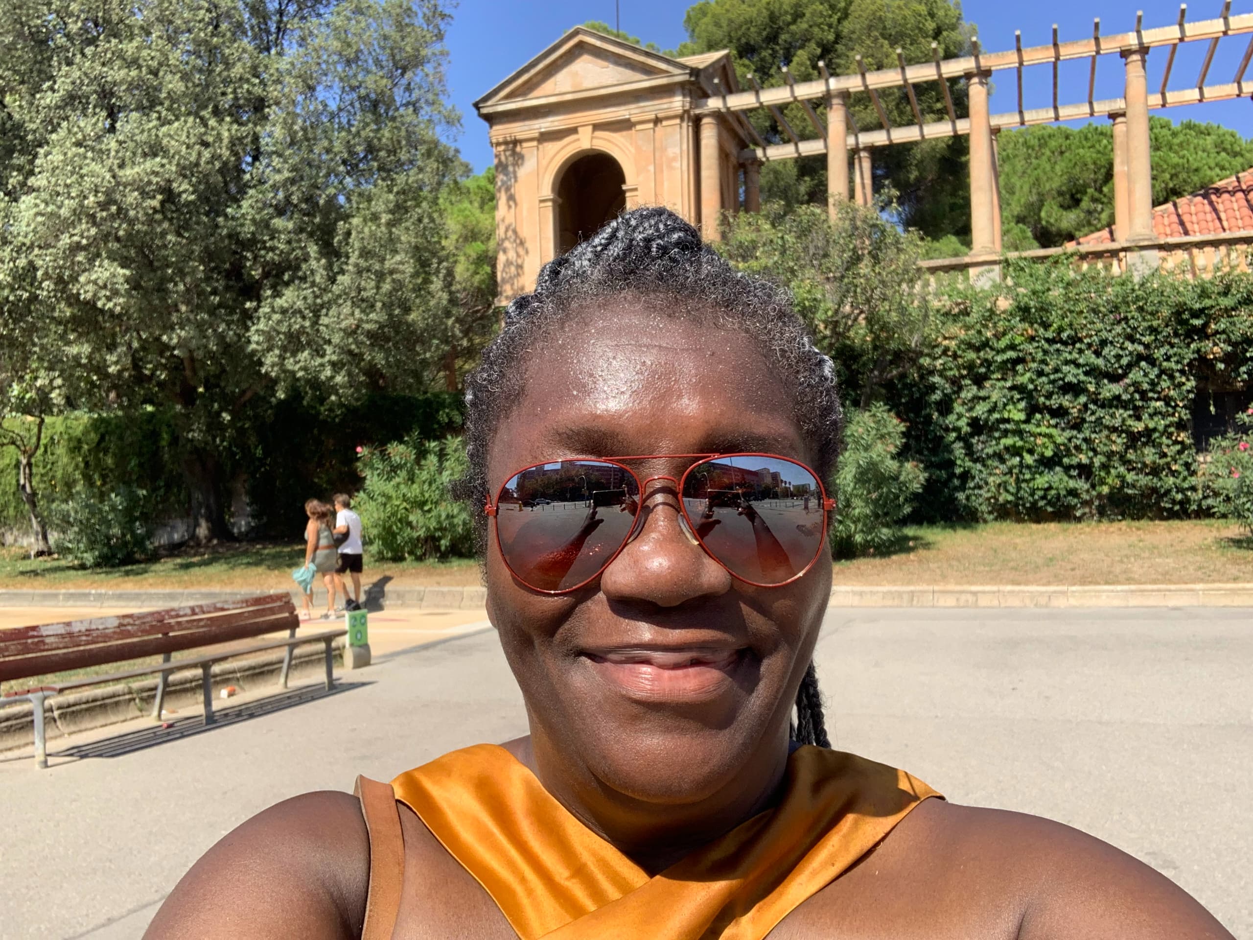 Anike taking a selfie in sunglasses with historic Barcelona architecture in the background