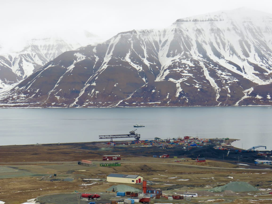 Aerial view of Longyearbyen airport area with ship in fjord