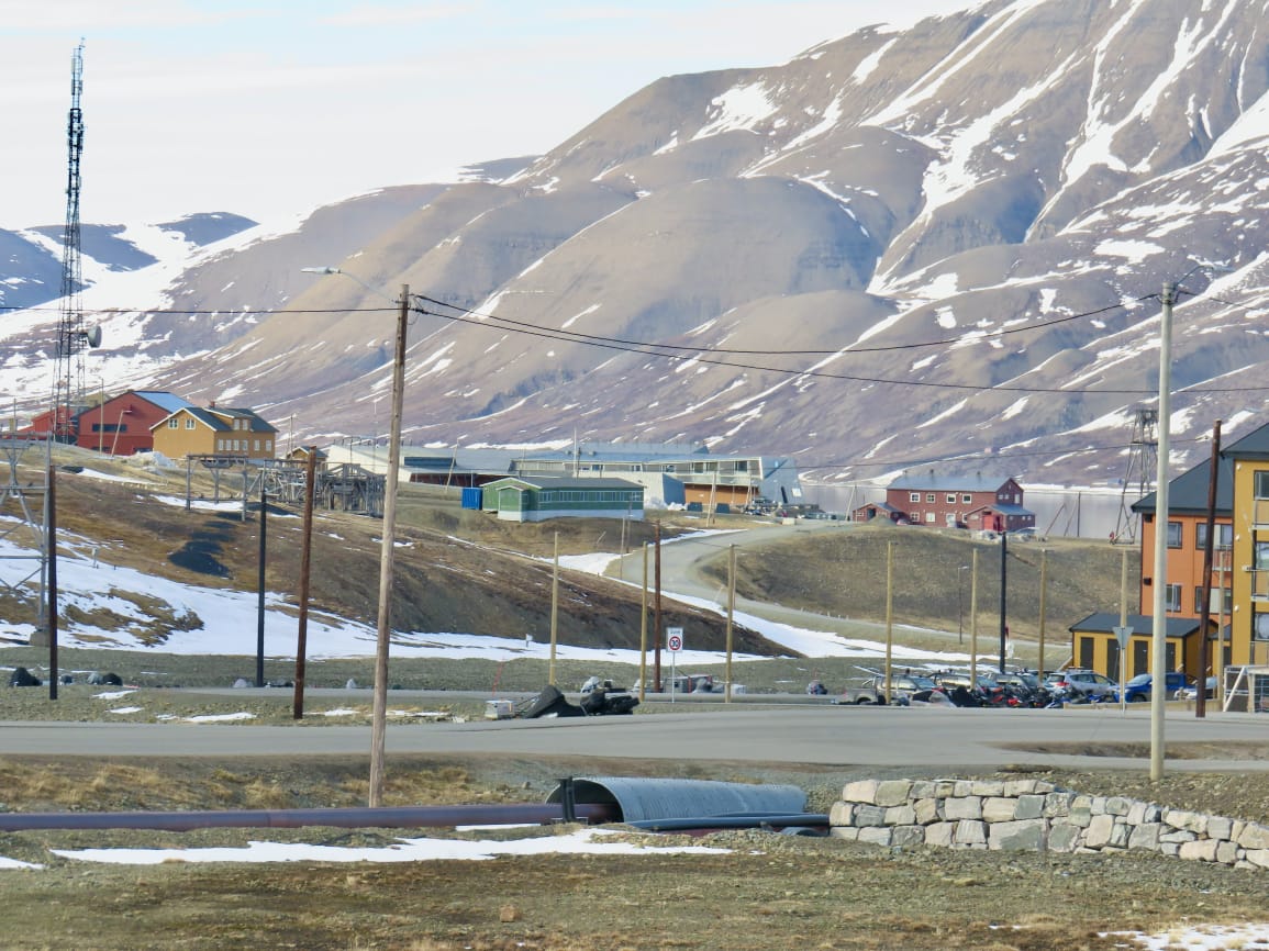 Panoramic view of Longyearbyen settlement with dramatic mountain backdrop