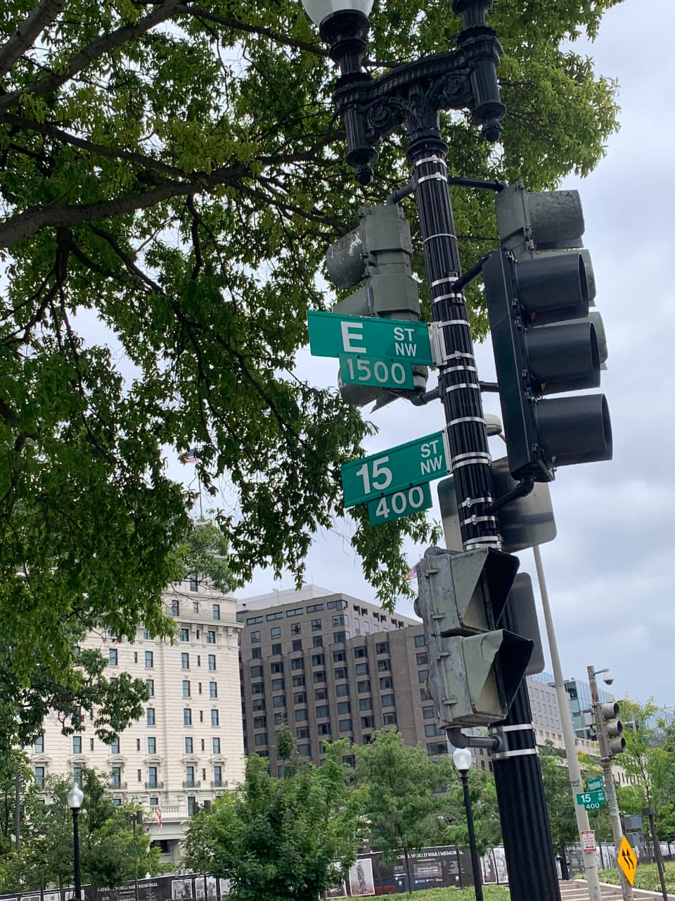 DC street intersection signs with classic architecture