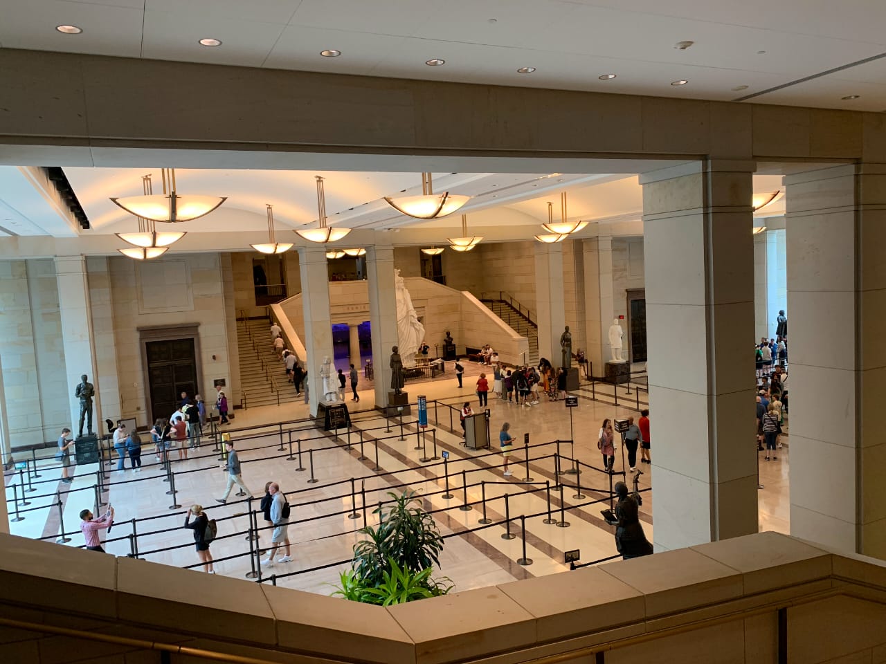 Museum grand staircase with classical architecture and visitors